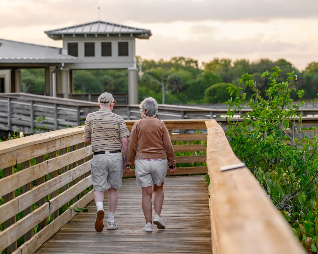 why-choose-us a-couple-of-people-that-are-walking-on-a-bridge-si7vsrzo0qc